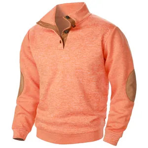 Detailed view of men's orange knit sweatshirt with buttoned collar and brown elbow patches