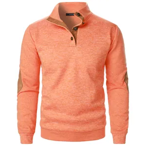 Macro view of men's orange knit sweatshirt featuring stand collar and elbow patches