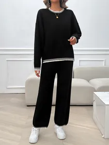 Women's black two-piece knit loungewear set with elegant white striped ribbing details