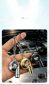 Detailed view of three metal turbo keychains in silver, gold, and black finishes.