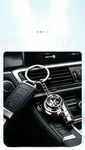 Detail shot of a polished metallic turbocharger-shaped keychain attached to a car key