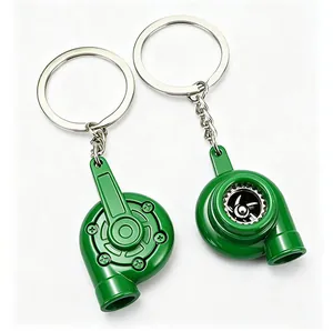 Detailed macro view of two green turbocharger keychains on a clean white background.