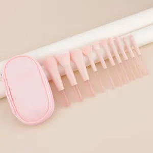 Set of 10 pink makeup brushes with transparent handles and a matching travel pouch