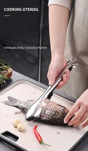 Manual stainless steel fish scale planer removing scales from a fish on a cutting board.