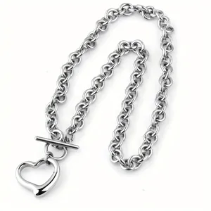 Detailed view of a silver stainless steel chunky chain necklace with a heart toggle pendant.