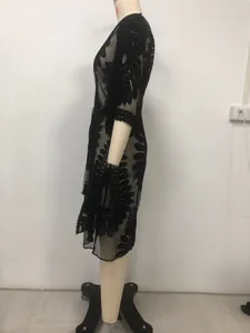 Detailed side view of black lace embroidered kimono cardigan used as beach cover-up