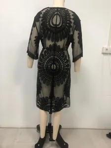 Detailed view of back intricate lace embroidery on black sheer beach cover-up cardigan