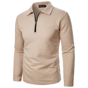 Close-up detail of the beige waffle knit fabric and half-zip collar on men's long sleeve polo shirt