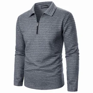 Close-up of a men's waffle knit quarter-zip polo shirt in grey with long sleeves