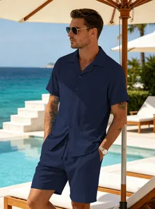 Detailed shot of a man wearing a navy blue textured short-sleeve resort set outdoors