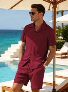 Detailed view of men's burgundy ribbed short-sleeved shirt and shorts set by a pool