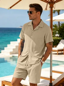 Lifestyle detail of men's beige ribbed short sleeve shirt and shorts set by a pool