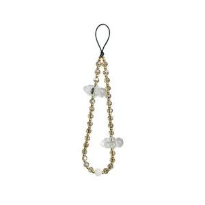Close-up of a handmade beaded phone strap with clear acrylic cloud pendants and gold beads.