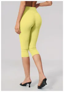 High-waisted yellow yoga capri pants showing back view and slim fit design