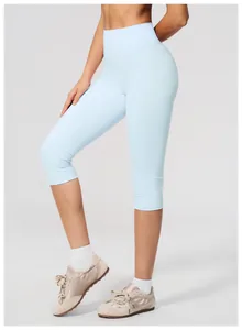 Side view of light blue high-waisted brushed yoga capri leggings for women fitness.