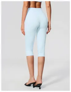 Back view of women's high-waisted light blue yoga capri pants for fitness training