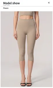 Detail shot of high-waisted beige yoga capris showing slimming fit and fabric texture