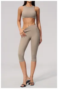 Full view of high-waist brushed yoga capris and sports bra set on a fitness model