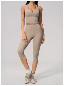 Beige two-piece yoga set with halter sports bra and high-waisted cropped leggings