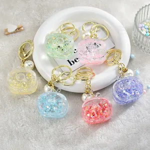 Detail of colorful TV-shaped acrylic keychains with floating star glitter and pearls.