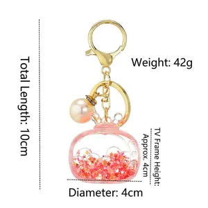 Acrylic television-shaped liquid keychain with red stars and pearl charm detail