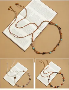Detail view of Bohemian hand-woven waist chains with decorative beads and tassels.