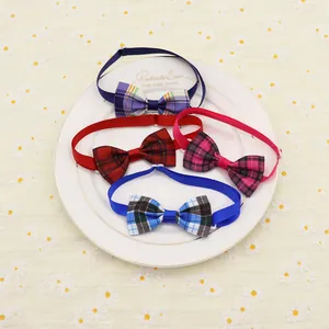 Detailed view of four colorful plaid pet bowties arranged on a white decorative plate