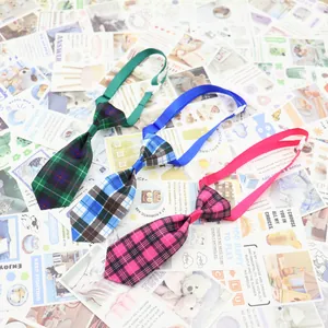 Close-up of three colorful plaid pet neckties for dogs and cats in green blue and pink