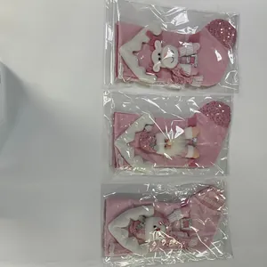 Detailed view of three pink Christmas stockings with cartoon designs in plastic packaging