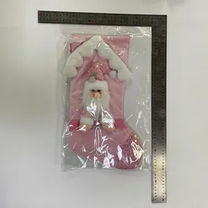 Pink sequin Santa Claus Christmas stocking with roof design measured by metal ruler