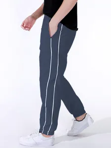 Men's navy blue paratrooper track pants featuring white side stripes and elastic cuffs.
