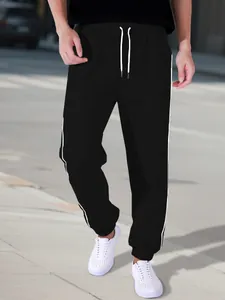 Men's black high street joggers with white side stripes and drawstring for sports