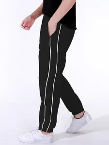 Detail of black men's high street athletic pants with double white side stripes