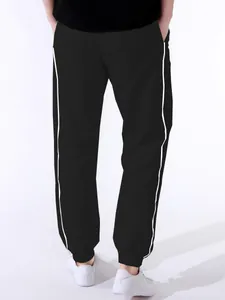 Detailed back view of men's black high street sports track pants with white side stripes