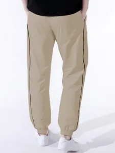 Detailed back view of men's khaki joggers featuring black side stripe and elastic cuffs