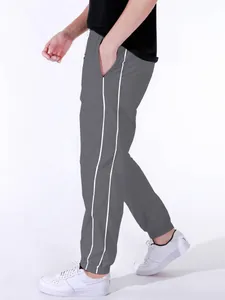 Detailed view of gray paratrooper pants featuring double white stripes on the side