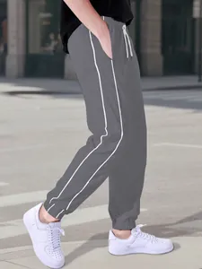 Grey men's casual joggers with white side stripes and elastic waist for outdoor sports