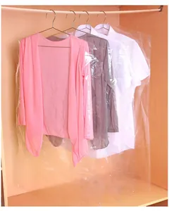 Detail view of transparent plastic garment dust covers hanging in a wooden closet