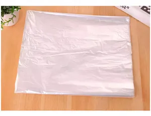 Detailed macro view of a folded transparent plastic garment dust cover for suit storage