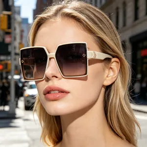 Detailed shot of a woman wearing oversized cream square polarized sunglasses in city