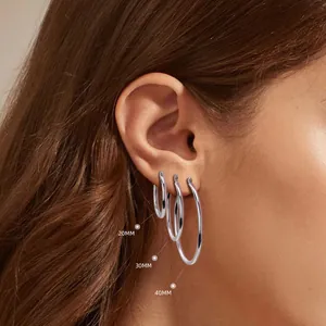 Detailed macro view of 20mm, 30mm, and 40mm S925 silver hoop earrings on a model