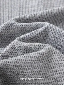 Close-up macro detail of high-quality grey ribbed fabric for women's slim fit T-shirt