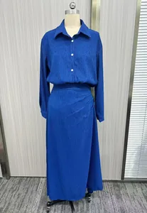 Detailed front view of a royal blue pleated dress with long sleeves and elegant buttons