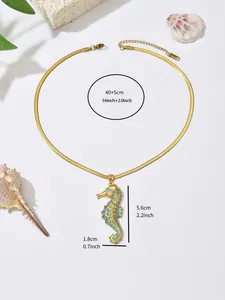 Detail view of gold seahorse pendant necklace with size measurements in cm and inches.