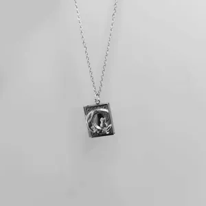 Elegant silver book locket necklace featuring a detailed cat on the moon design.
