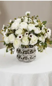 Elegant artificial white peony and daisy flower bouquet displayed in a silver textured vase