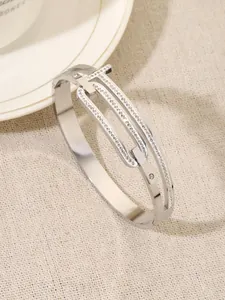 Close-up of titanium steel bangle with sparkling crystal encrusted T-shaped link