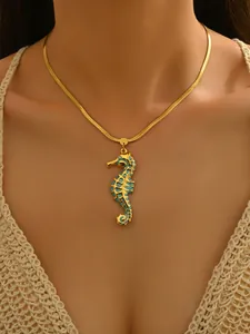 Close-up of gold plated stainless steel necklace with blue enameled seahorse pendant