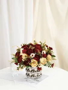Detailed view of realistic artificial peony bouquet in a silver metallic textured vase