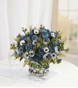 Detailed close-up of a blue artificial peony bouquet arranged in a textured silver vase